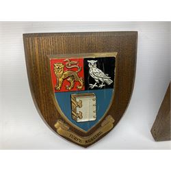 Framed sampler and two armorial plaques 