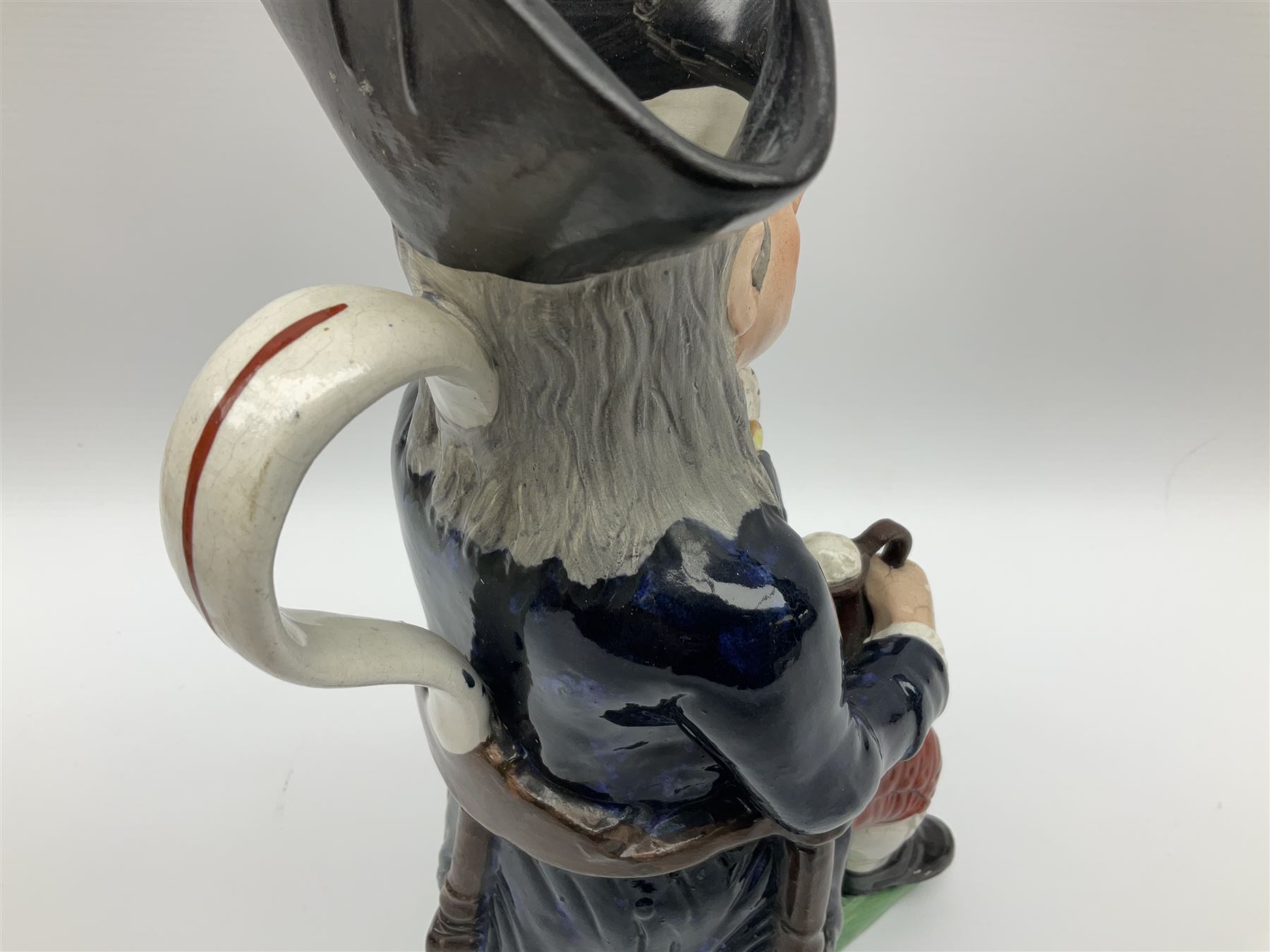 Early 20th century Staffordshire William Kent Squire toby jug, modelled seated upon a corner chair holding a jug of ale in his right hand, H28cm
