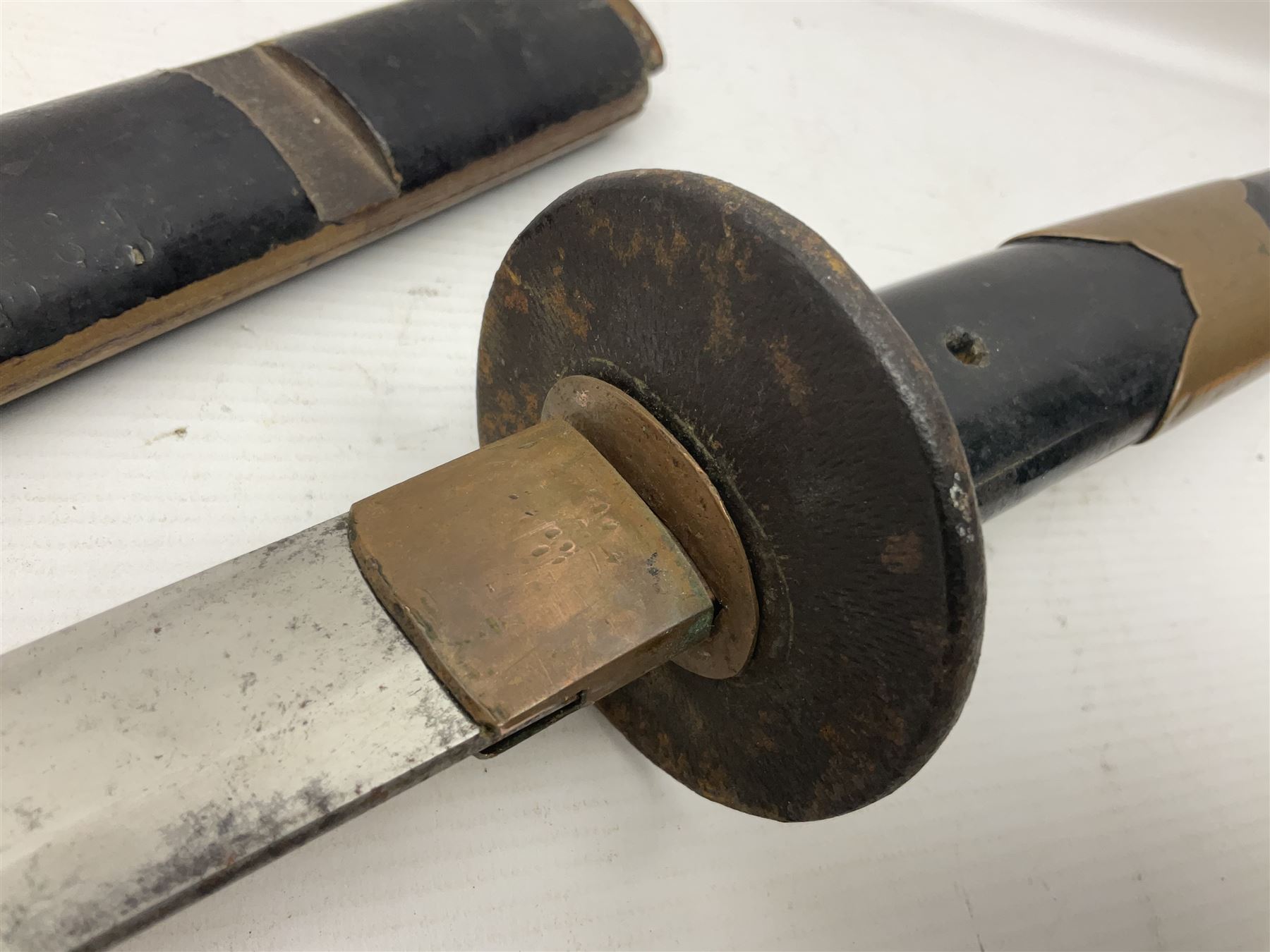 Good quality Japanese sword blade with later WWII fittings and scabbard  - 67.5cm slightly curving blade with unmarked tang, plain iron tsuba and lacquered grip with copper mounts; in lacquered wooden scabbard with tape bound tip L94cm overall