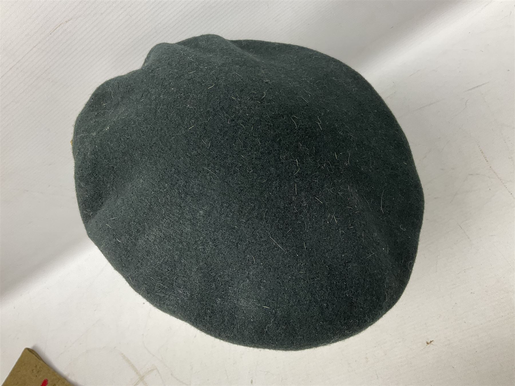 WW1 British Army Derby Scheme 1915 Attested armband; beret with East Yorkshire cap badge; pair of fur lined leather flying/motorcycle goggles; HMS Pembroke cap band; and small quantity of RNAS cloth and metal badges etc