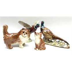 A collection of Beswick figures, comprising ginger cat model no 1898, ginger Persian kitten model no 1886, pheasant in flight model no 849, and pheasant model no 1226b.  