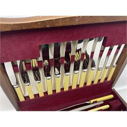 Silver plated canteen of cutlery with ivorine handles, for six plate settings, including fish knives and forks, contained within wooden chest with one drawer