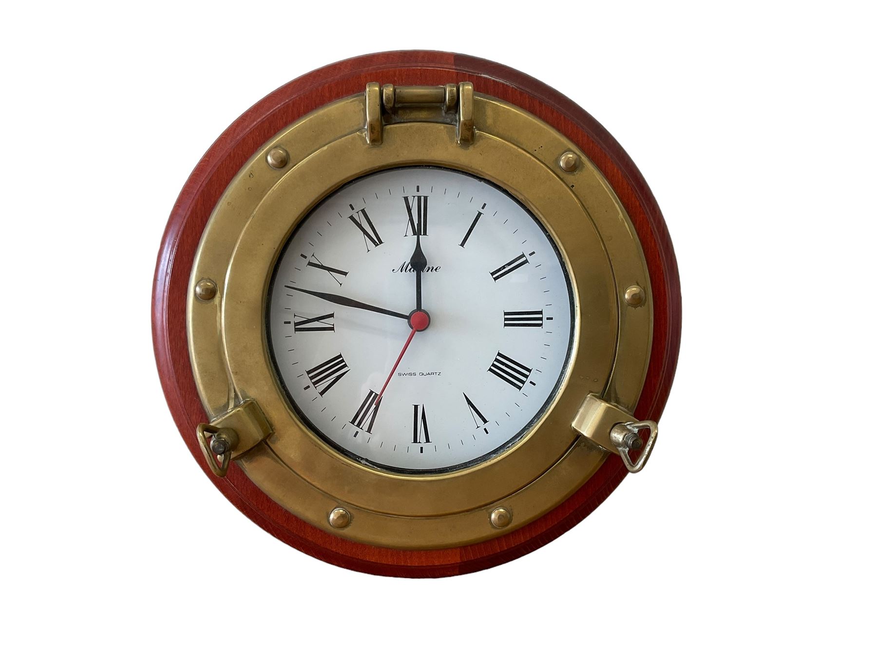 20th century marine clock with a mahogany surround and cast brass “porthole” bezel, with a 6” dial and Swiss battery operated quartz movement.