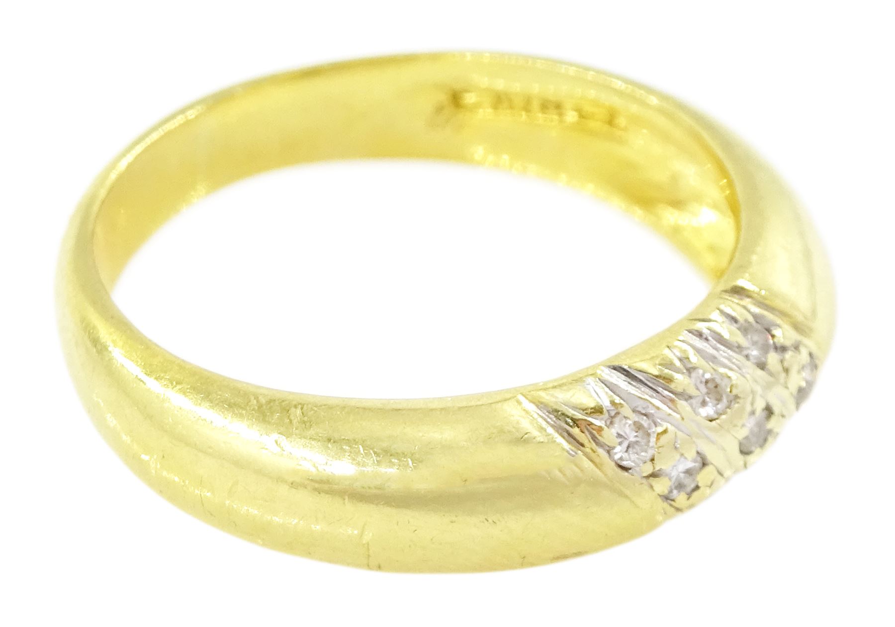 Gold diamond ring, rubover set with nine round brilliant cut diamonds