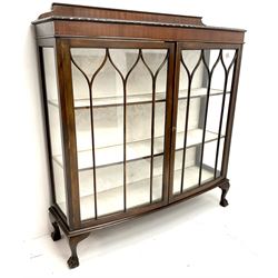 Early 20th century mahogany display cabinet, raised shipped back, two glazed doors enclosing two lined shelves, cabriole ball and claw feet