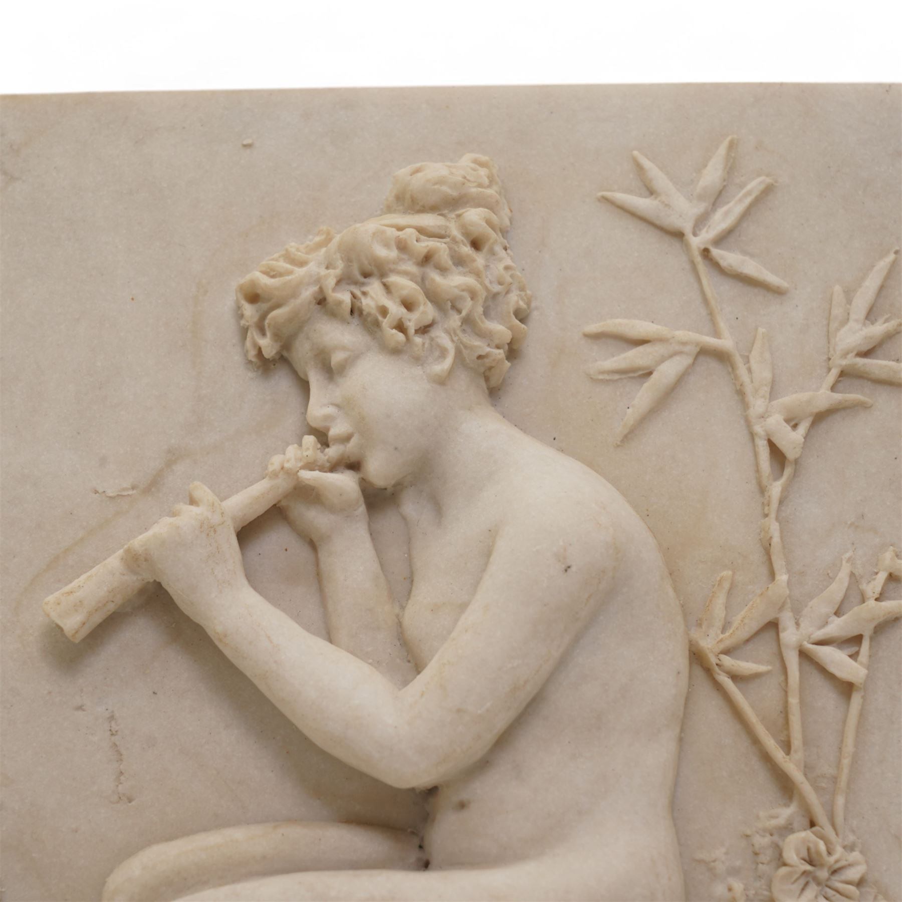 Composite plaque, depicting Sprites in a garden, with inset 'Arts and Commerce Promoted' medallion to reverse, 20cm x 33cm; together with a moulded glass Claret jug with silver plated mount H30cm 