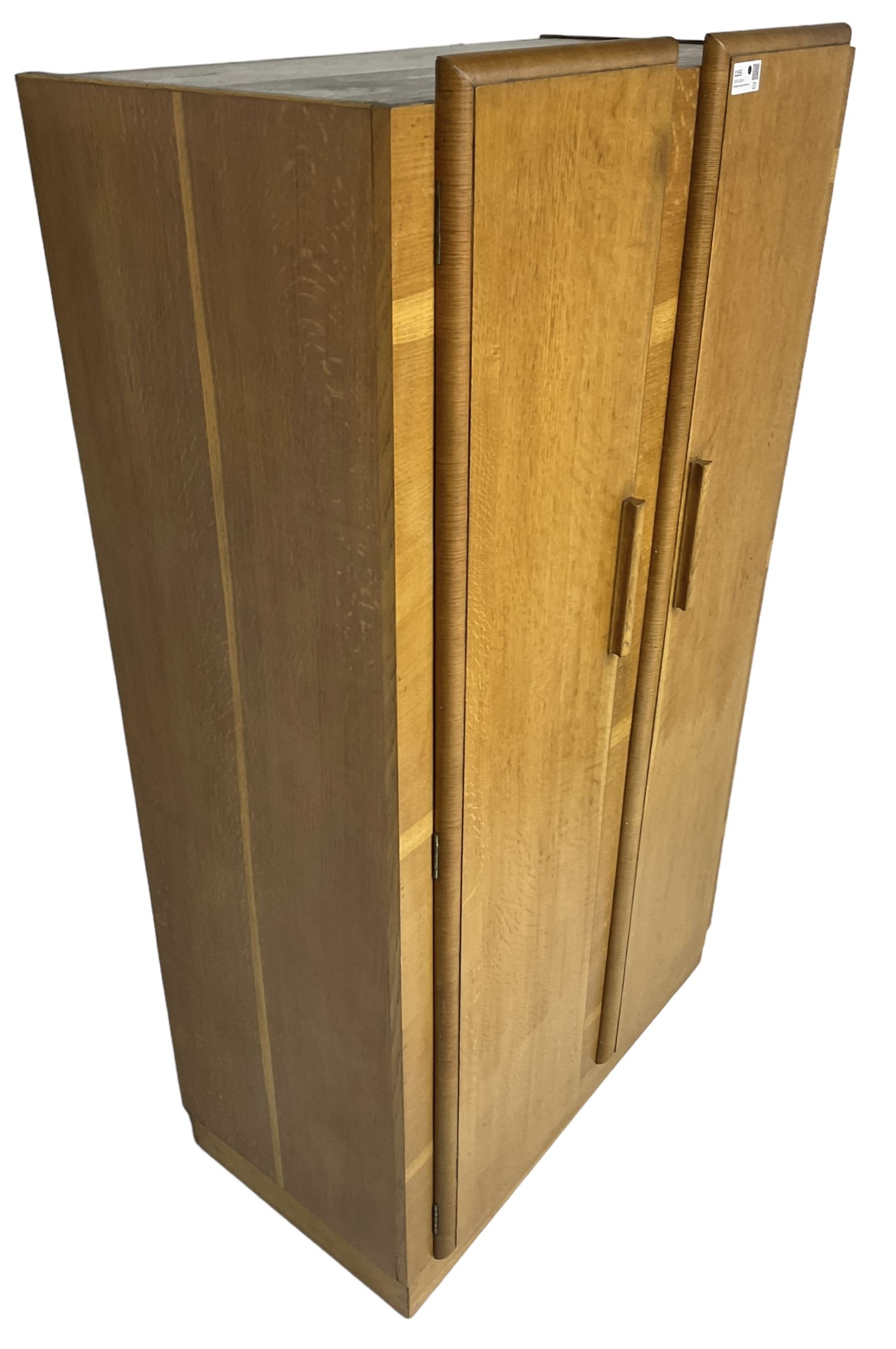 Early 20th century Art Deco period oak Gentleman's wardrobe, the interior fitted with shelves, hanging rails and two long drawers