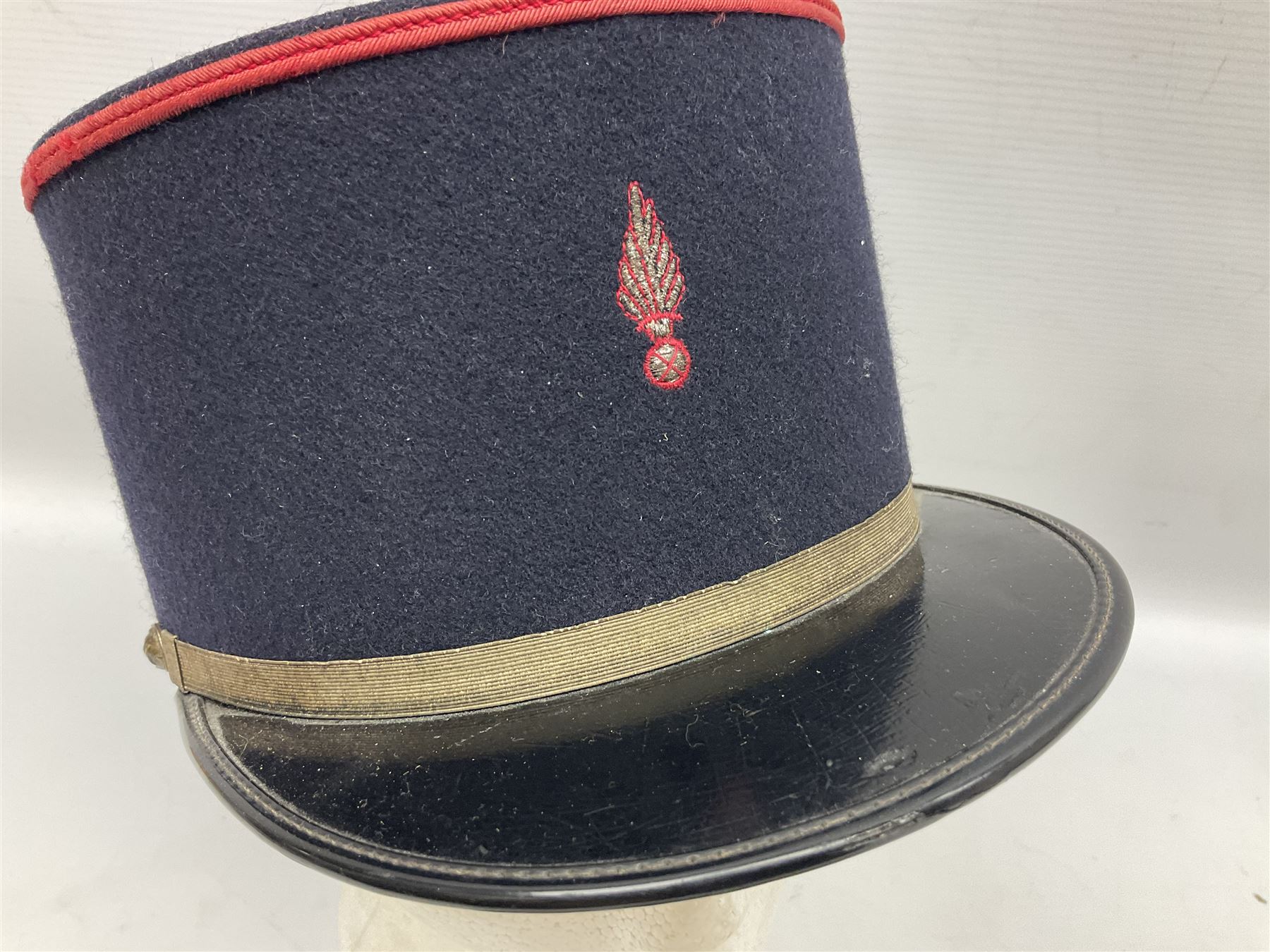 Mid 20th century French Ugeco Nantes first class dress navy blue uniform with ribbon bar with cap, and quantity of Sapeurs Pompiers patches, Sapeurs Pompiers de Caen belt buckle etc