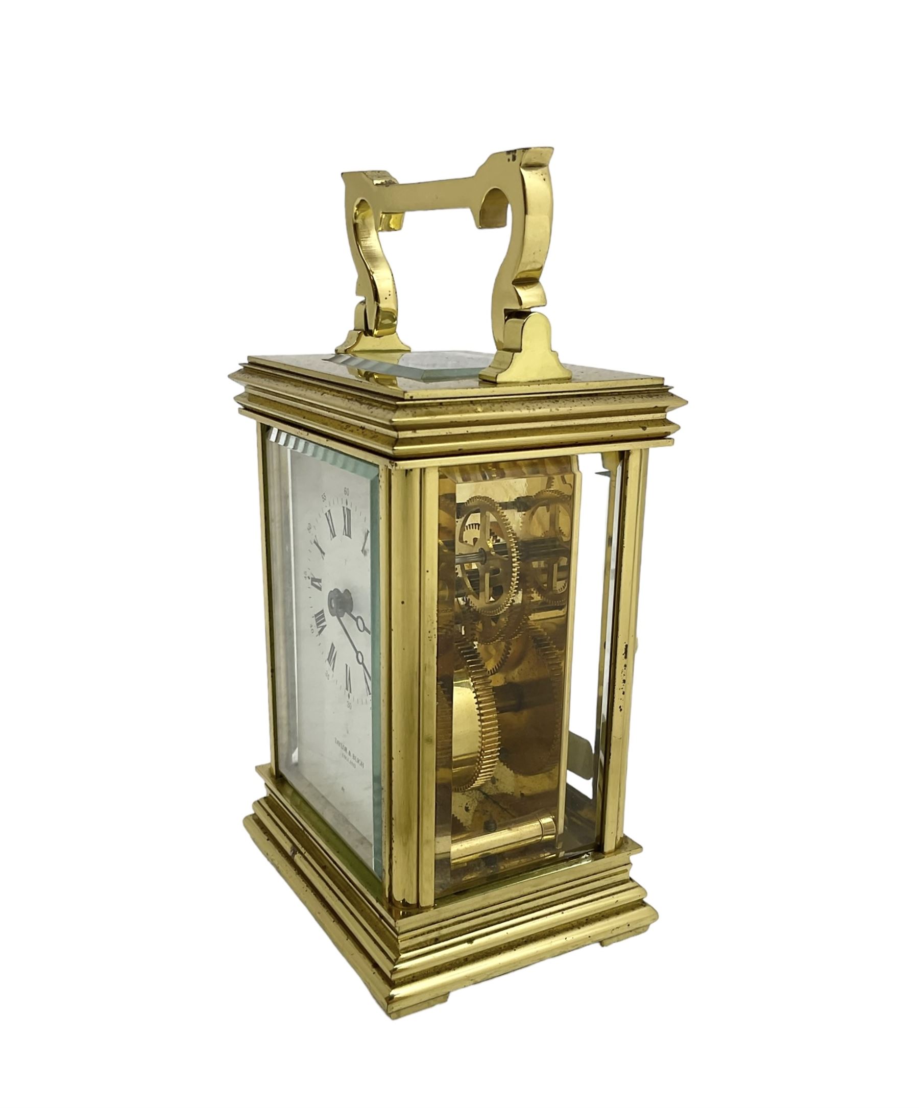 English - late 20th century 8-day carriage clock by Taylor & Bligh, in an Anglaise case with a rectangular handle, bevelled glass panels and enamel dial with Roman numerals, minute markers and steel moon hands, timepiece spring driven movement with a jewelled lever platform escapement. With key.