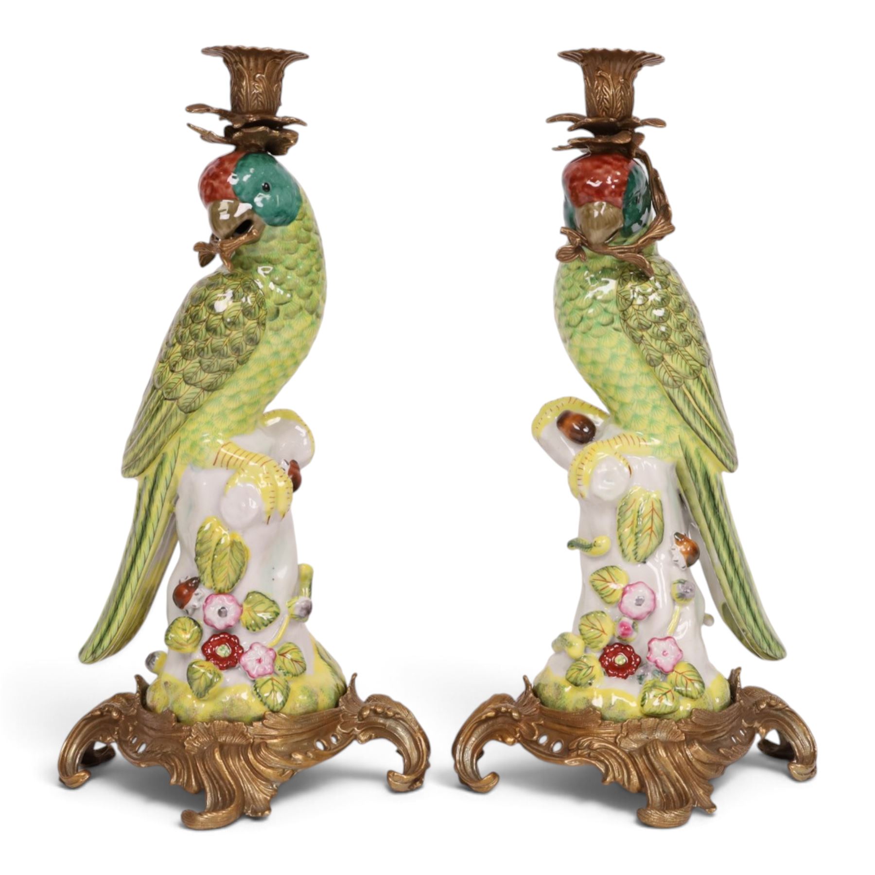 Pair of candlesticks, modelled as green parrot upon a flowering branch, upon four gilt acanthus leaf feet, H36cm