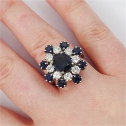 18ct white gold sapphire and diamond cluster ring, single oval cut sapphire of approx 1.85 carat, surrounded by eight round brilliant cut diamonds and eight round cut sapphires, stamped Graff, total sapphire weight approx 3.40 carat, total diamond weight approx 1.35 carat
