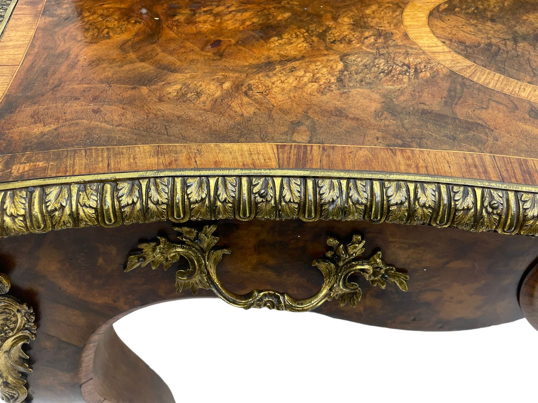 Late 19th to early 20th century French figured walnut writing desk, raised back fitted with drawers, shaped top with Kingwood banding and foliage cast edge moulding, fitted with single drawer, on cabriole supports mounted by shell and flower head cartouches 