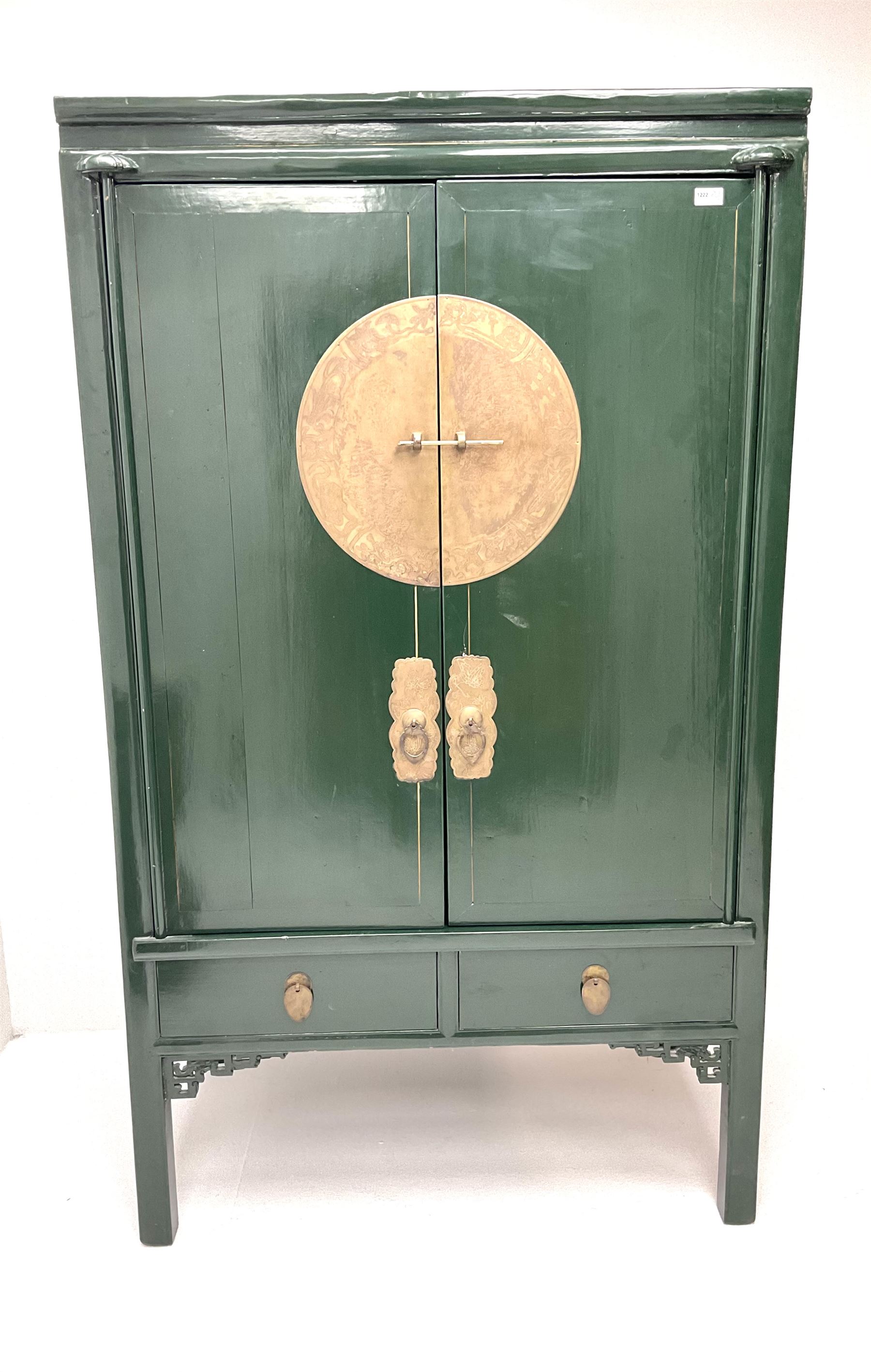 Chinese 'moon' rosewood raised cabinet, hammered brass centre piece featuring floral design, two cupboard doors enclosing two tiers and two short drawers, above two short drawers, shaped trim and stile supports 