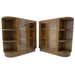 Pair of mid-20th century oak bookcases, rectangular form with curved ends, enclosed by glazed doors and fitted with shelves