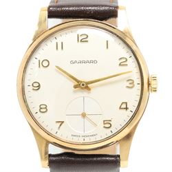 Garrard gentleman's 9ct gold manual wind wristwatch, silvered dial with Arabic hour markers and subsidiary seconds dial, the back case with personalised engraving, London 1974, on brown leather strap