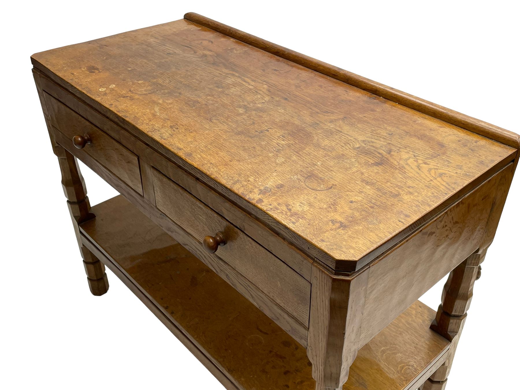 Mouseman - circa. 1950s oak serving table, adzed rectangular top over two drawers, on octagonal supports joined by adzed undertier, the rear right leg carved with mouse signature, by Robert Thompson of Kilburn