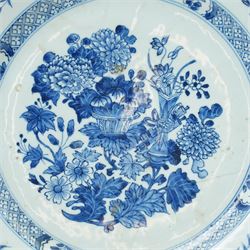 18th century Chinese oval dish shallow dish decorated with flowers in blue and white within a scroll and key pattern border W37cm and a Chinese blue and white charger D34cm (2)