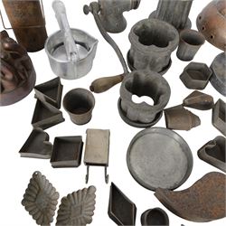 Two copper jelly moulds, collection of metal cookie cutters and moulds, LF&C nut butter grinder, fruit press and other metalware