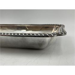 Early 20th century silver entree dish and cover, of rectangular form with shaped corners and oblique gadrooned borders to base and cover, the cover with loop 'bamboo' handle, hallmarked Thomas Bradbury & Sons Ltd, Sheffield 1930, including handle H10.5cm L24.5cm