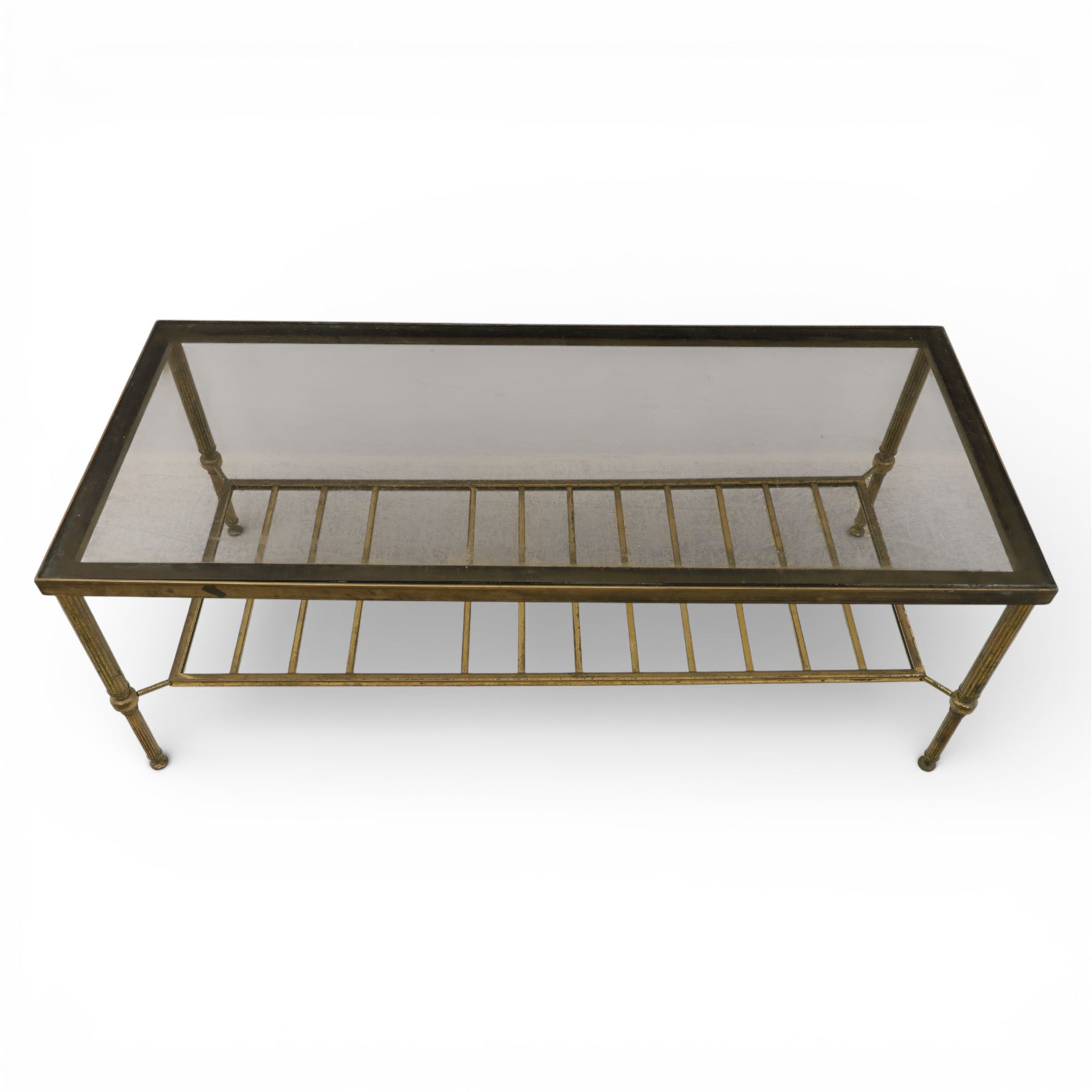 20th century brass and glass topped coffee table, the rectangular glass top within brass frame, upon four reeded legs united by lower slatted under tier 