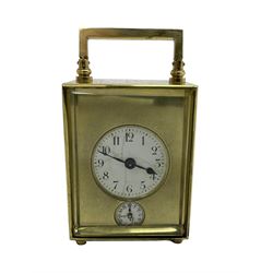 Petite French carriage clock - early 20th century timepiece movement with an alarm sounding on a bell, circular enamel dial with a brass mask, Arabic numerals, minute markers, spade hands and conforming alarm setting dial beneath, going barrel movement with a lever platform escapement, wound and set from the rear, with original leather travel case and key, 