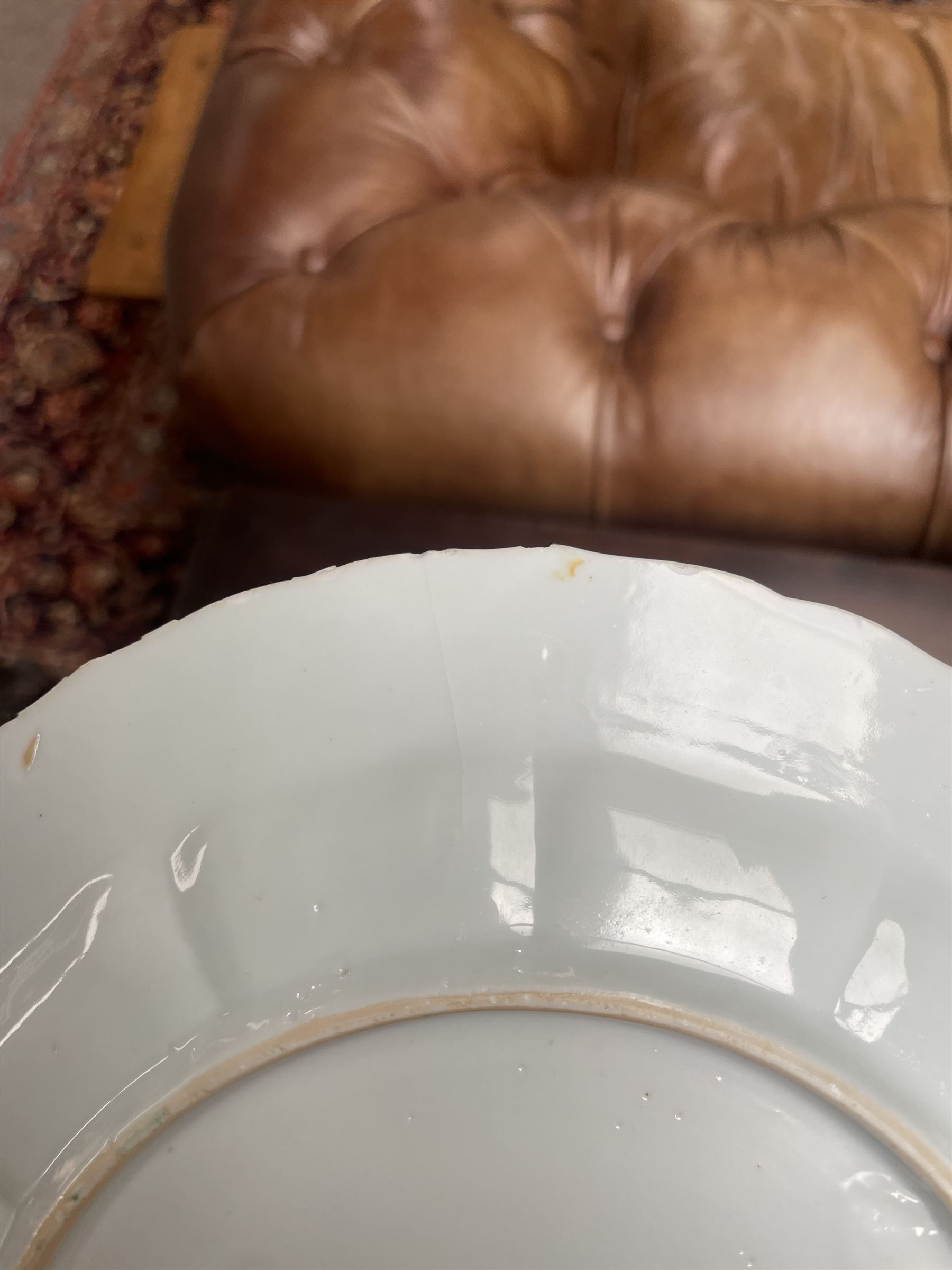 Chinese Kangxi famille verte plate, decorated with a bird perched upon a blossoming branch, within an iron red foliate border, D22cm