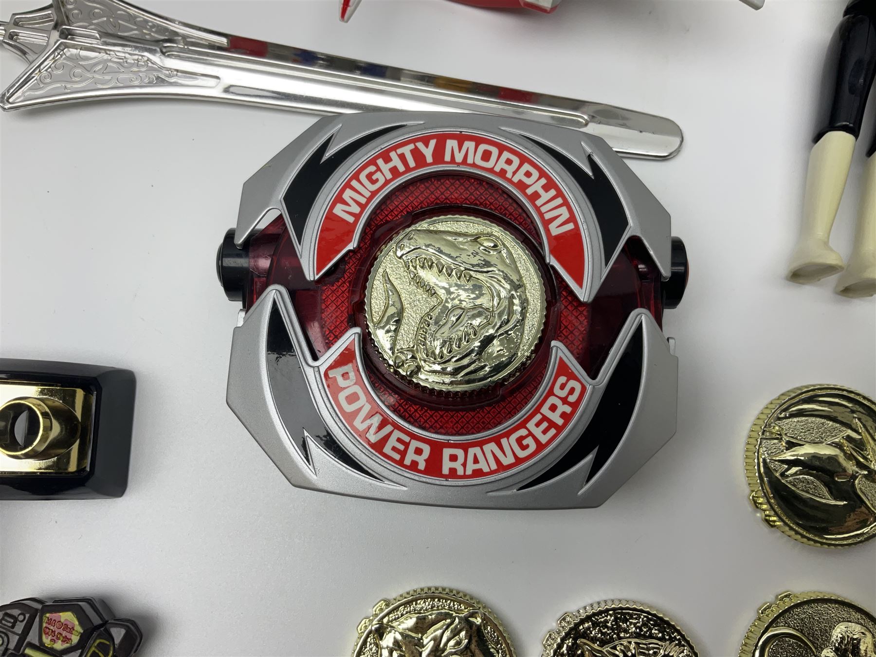 Collection of early 90s Mighty Morphin’ Power Rangers Zords, figures and accessories. Titanus the Carrier Zord, marked Bandai 1991; Green Dragonzord, incomplete; 1994 White Tigerzord with original instruction manual; 1993 Triceratops Dinozord, Mastodon Dinozord and Sabertooth Tiger Dinozord, Pterodactyl Dinozord, missing guns; with 1993 Power Morpher and original Power Coins, with further related figures, accessories and weapons