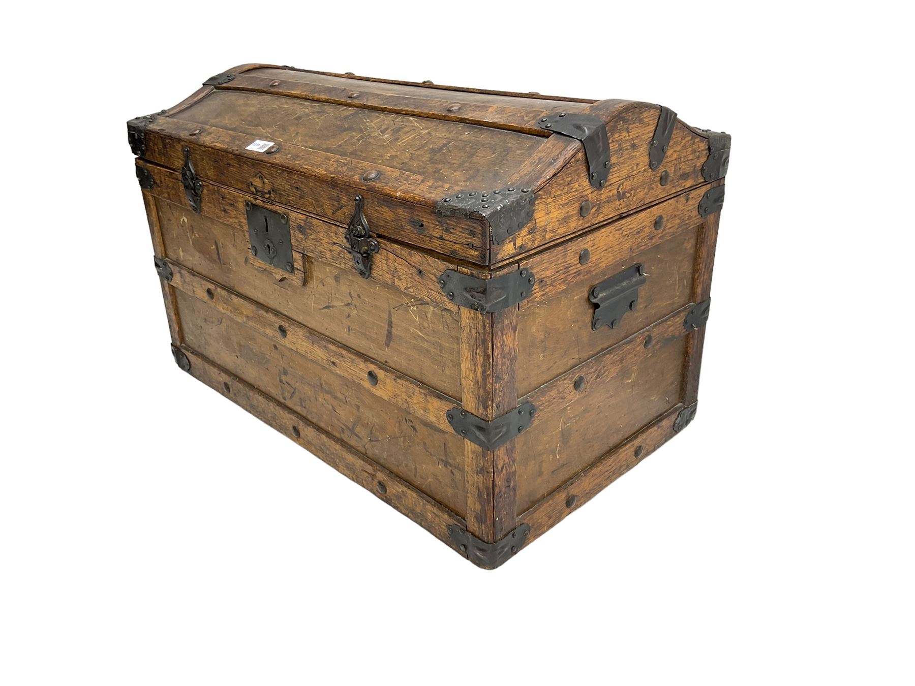 Late 19th to early 20th century oak framed travelling trunk, dome top with iron fittings and panelled sides and top, interior labelled 'The Anchor Patent Waterproof Travelling Trunk - 1902'