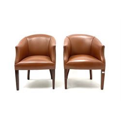 Pair tub chairs, upholstered in studded tan faux leather, raised on square tapering supports 