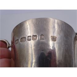 Modern Arts and Crafts style silver jug, of tapering form with capped C handle and hammered finish throughout, upon circular foot, hallmarked John Henry Pank, London 1977, with Hull town mark, H11cm