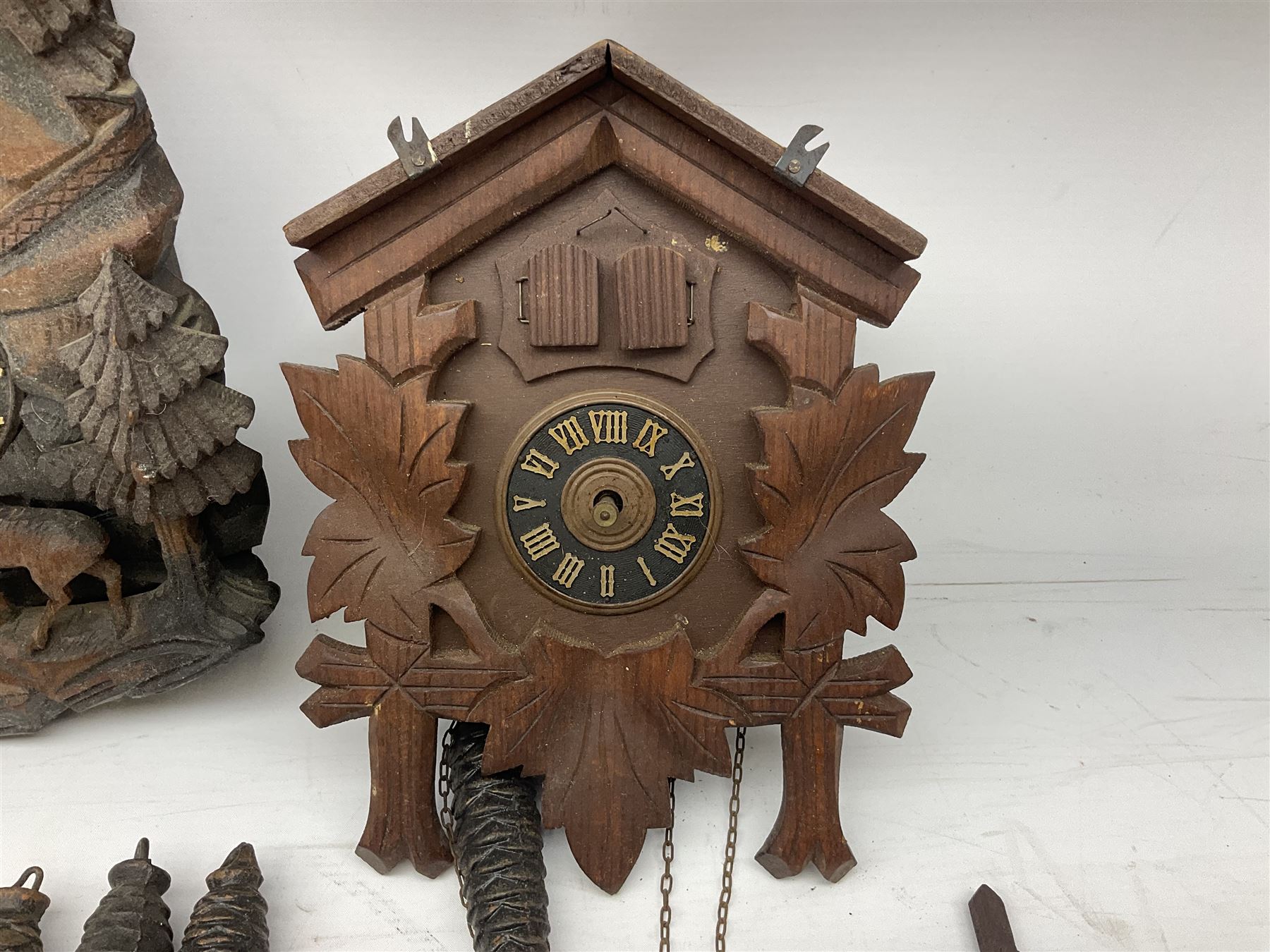 Three 20th century cuckoo clocks and weights for parts or repair