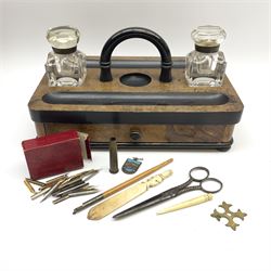 A Victorian burr wood and ebonised desk stand, with two pen trays, and two cuboid glass inkwells flaking a central half round handle, above a single base drawer, H15cm L30cm D19.5cm 