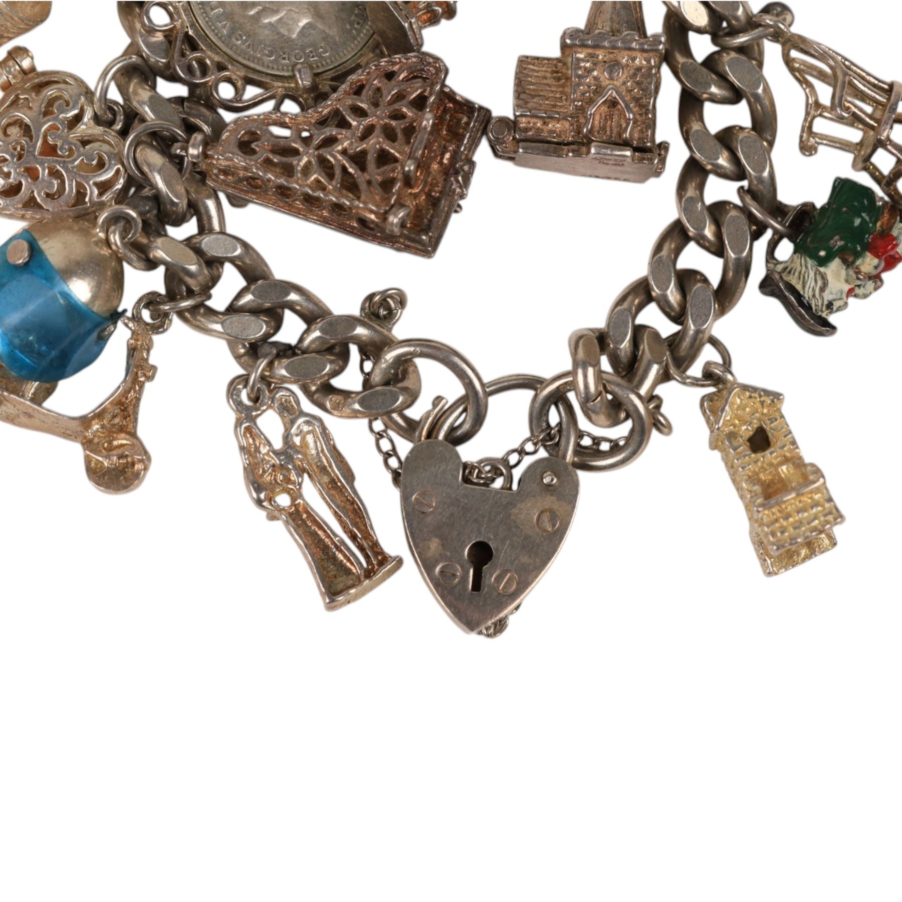 Silver charm bracelet, with seventeen charms including motorbike helmet, enamel toby jug, piano, etc