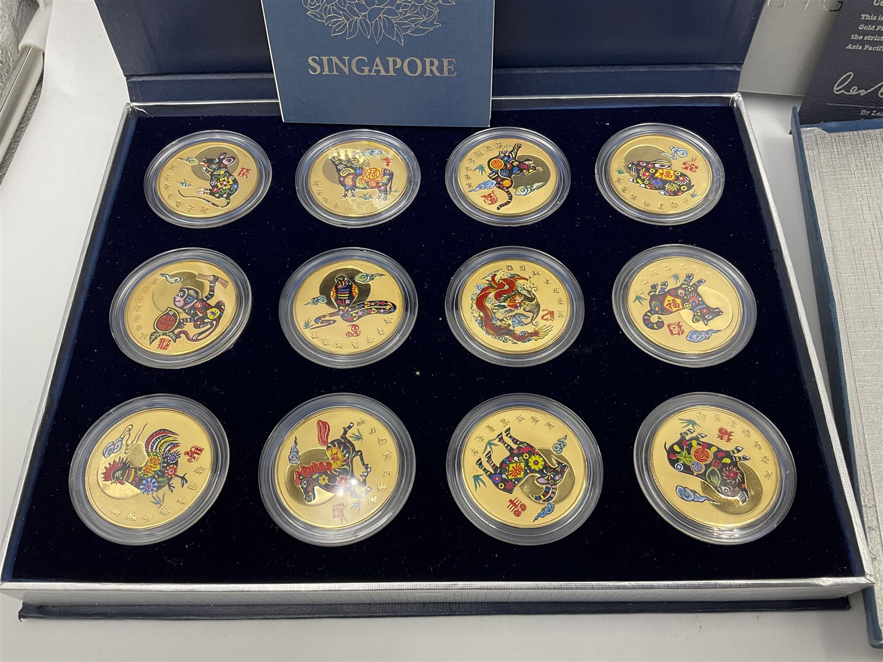 Singapore Venhonia commemorative medallion collection and a Tiger Beer commemorative three-medallion collection, both cased with certificates
