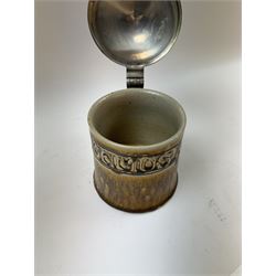 Arts and Crafts or Jugendstil tankard by Richard Riemerschmid, circa 1906, the cylindrical stoneware body reading 'Gaudeamus Igitur' (therefore let us rejoice), and finished in a brown glaze, with engraved slightly domed hinged lid, impressed mark beneath for Reinhold Merkelbach Grenzhausen, model number 2026 W, H14.5cm 