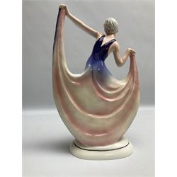 Early 20th century Hertwig Katzhütte figure of an Art Deco lady dancing, wearing a pink and purple dress, stood upon on a domed plinth, with green cat H house printed mark beneath, H32cm
