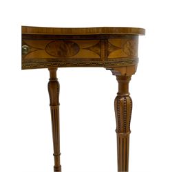 Fine 20th century satinwood kidney-shaped lamp or side table, the top inlaid with central figured panel surrounded by trailing fruiting foliage and ribbon tie, within crossbanding and stringing, fitted with single frieze drawer, the frieze rail inlaid with alternating figured geometric panels, on ring turned supports carved with vertical bead decoration over inlaid fluting, united by curved stretchers 