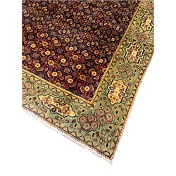 Persian Mahal rug, the blue ground field decorated with repeating Herati motifs, guarded pale ground border decorated with stylised panels