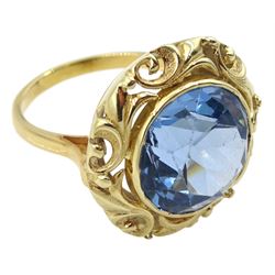 18ct gold single stone round synthetic blue spinel ring, with pierced leaf border