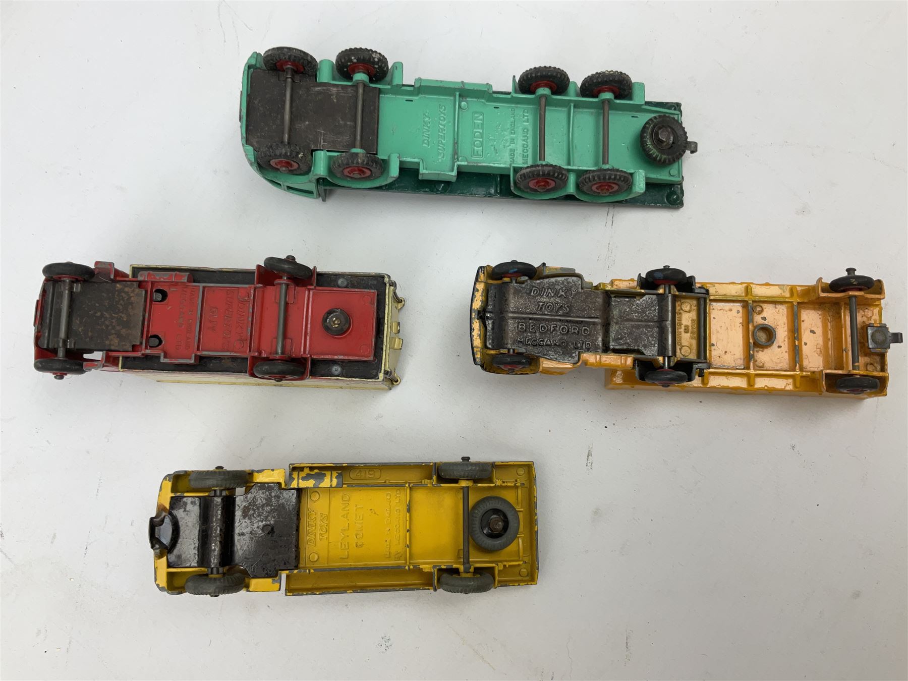Dinky - eight unboxed and playworn/repainted commercial vehicles including Foden flatbed lorry, Bedford Articulated lorry, Leyland Comet Ferrocrete lorry, Guy Spratts panel van, Fire Engine, Jones Fleetmaster, Commer breakdown truck etc (8)