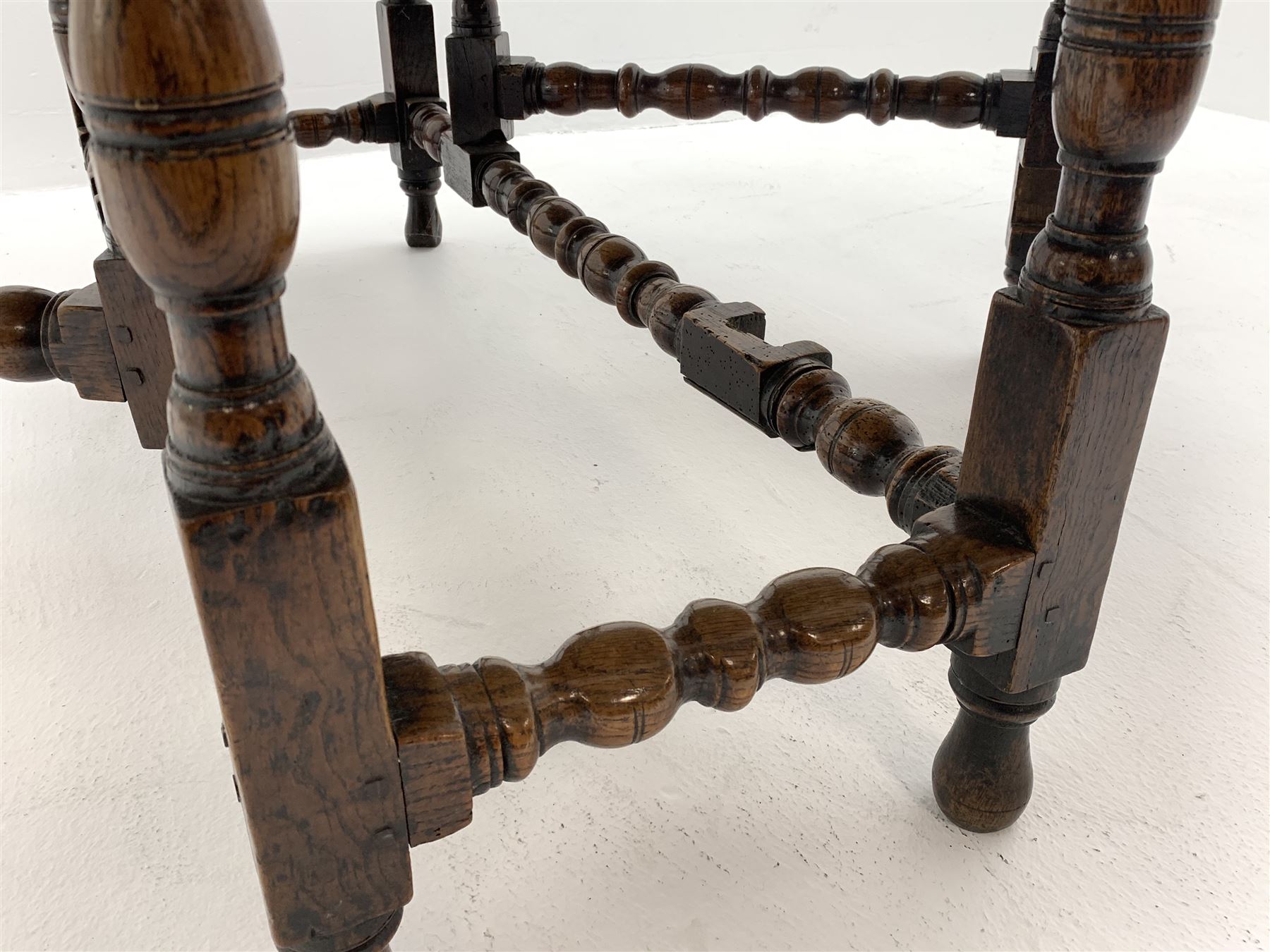 Late 17th century William & Mary oak drop leaf dining table, oval drop leaf top, single drawer to one end, gate action base, turned supports joined by bobbin turned stretchers, 121cm x 135cm, H75cm (open)