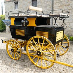 Roof Seat Break by Shanks of London

A roof seat break by Shanks of London built on a perch in black and yellow livery, the body fitted with an elevated driver's box seat, elevated rear groom's seat and central passenger compartment. The carriage is mounted on wooden spoked wheels with leaf spring suspension and is equipped with louvred underbody storage compartments, carriage lamp brackets (lamps next lot), folding access steps and a pole for driving with a pair or team of horses. The wheel hubs are stamped 