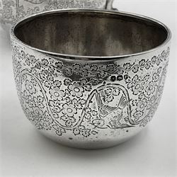 Late Victorian silver bachelors three piece tea service, comprising bullet shaped teapot, open sucrier and milk jug, each engraved with monogram surrounded by birds upon and amidst a blossoming vine, the teapot with scroll capped curved wooden handle and wooden finial to cover, hallmarked Wakely & Wheeler, London 1890, teapot including handle H12cm, sucrier H5.5cm 