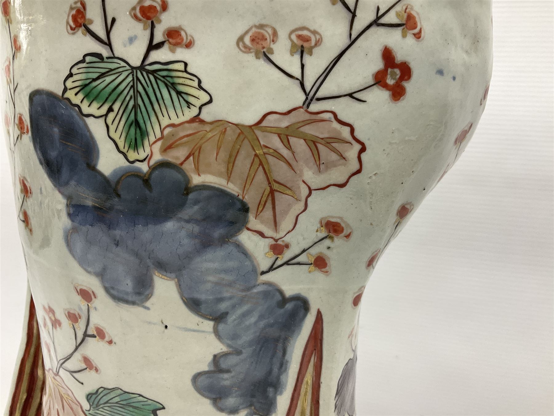 Large Japanese Imari porcelain figure, modelled as a Bijin, wearing a long kimono decorated with apple blossom and leafy branches on a white ground, with gilt detailing, possibly Edo period, H63cm