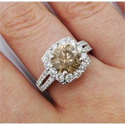 18ct white gold round brilliant cut fancy light brown diamond ring, with halo diamond surround and diamond set shoulders, stamped 750 18K, central diamond 2.00 carat, total white diamond weight 0.90ct