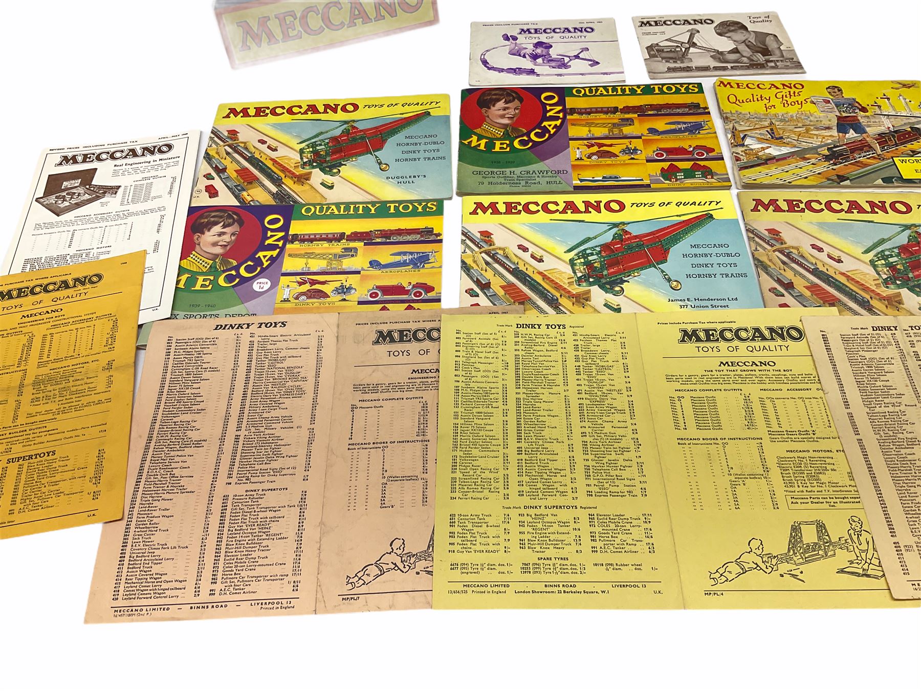 Meccano - toy shop point-of-sale cardboard advertising sign with easel back, depicting a boy finishing a large Eiffel Tower H37cm; nine catalogues 1938/9, 1939/40, 1952, 1953, three x 1956, 1958 and HRCA 1994 copy of 1939/40, bearing various toy shop addresses to front covers, some with price lists; and seven price lists 1949 - 1966.