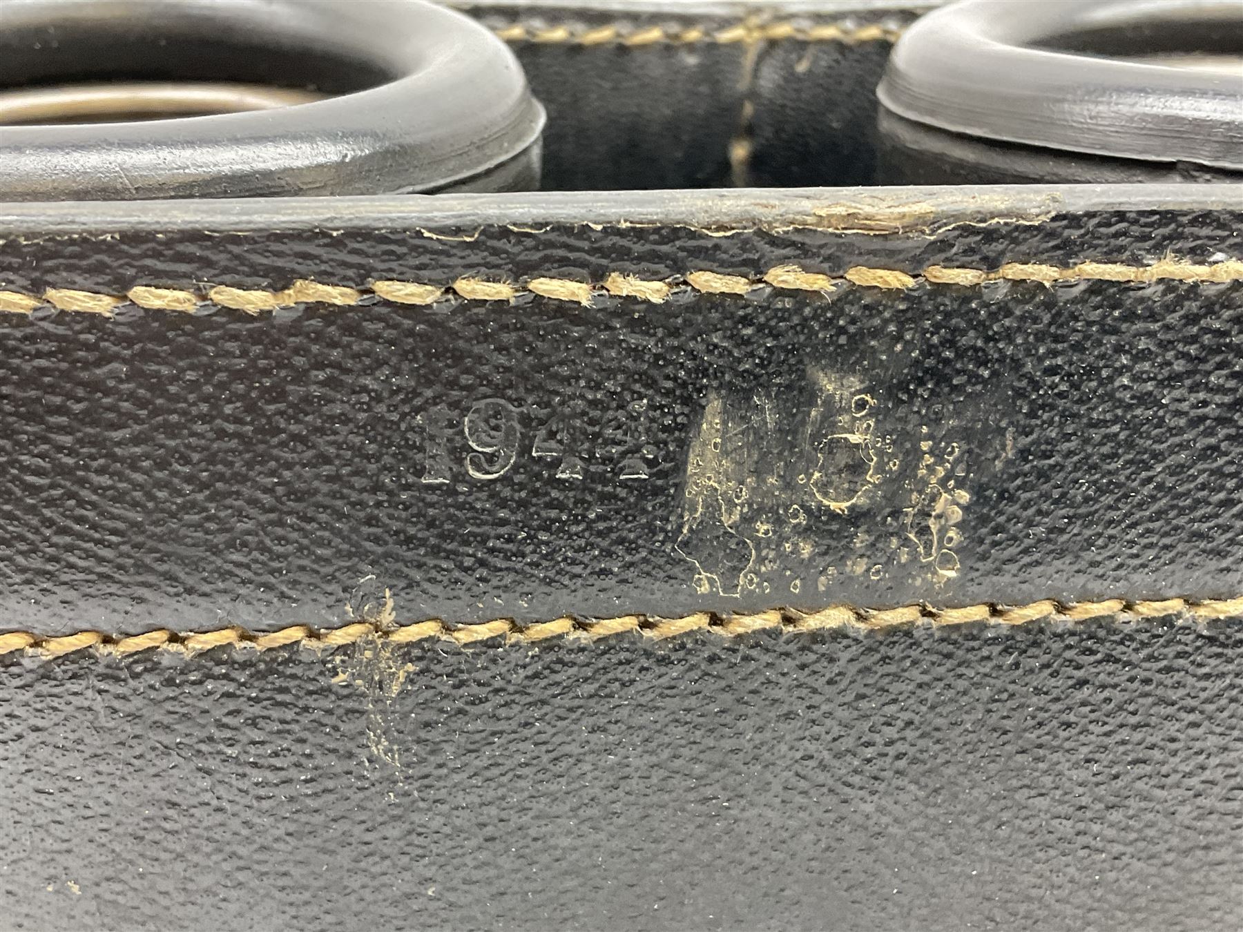 Pair of WWII German U-boat binoculars probably 7 x 50 by Leitz, with rubber eye piece protector covers and leather case stamped with Kriegsmarine mark to the lid and dated 1944, with leather strap.