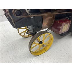 Scratch-built red and yellow painted live-steam scale model of a Showman's Traction Engine, 'Supreme' S.A. Oates & Sons, the simulated planked wooden canopy with twisted brass supports and rope light edging, 19cm flywheel, 32cm diameter rear wheels with solid rubber tyres and 21cm diameter front wheels L102cm; together with scratch-built ride-on two-wheel trailer L58cm, Franzus step-down transformer and various brass rally plaques for 1980s/1990s