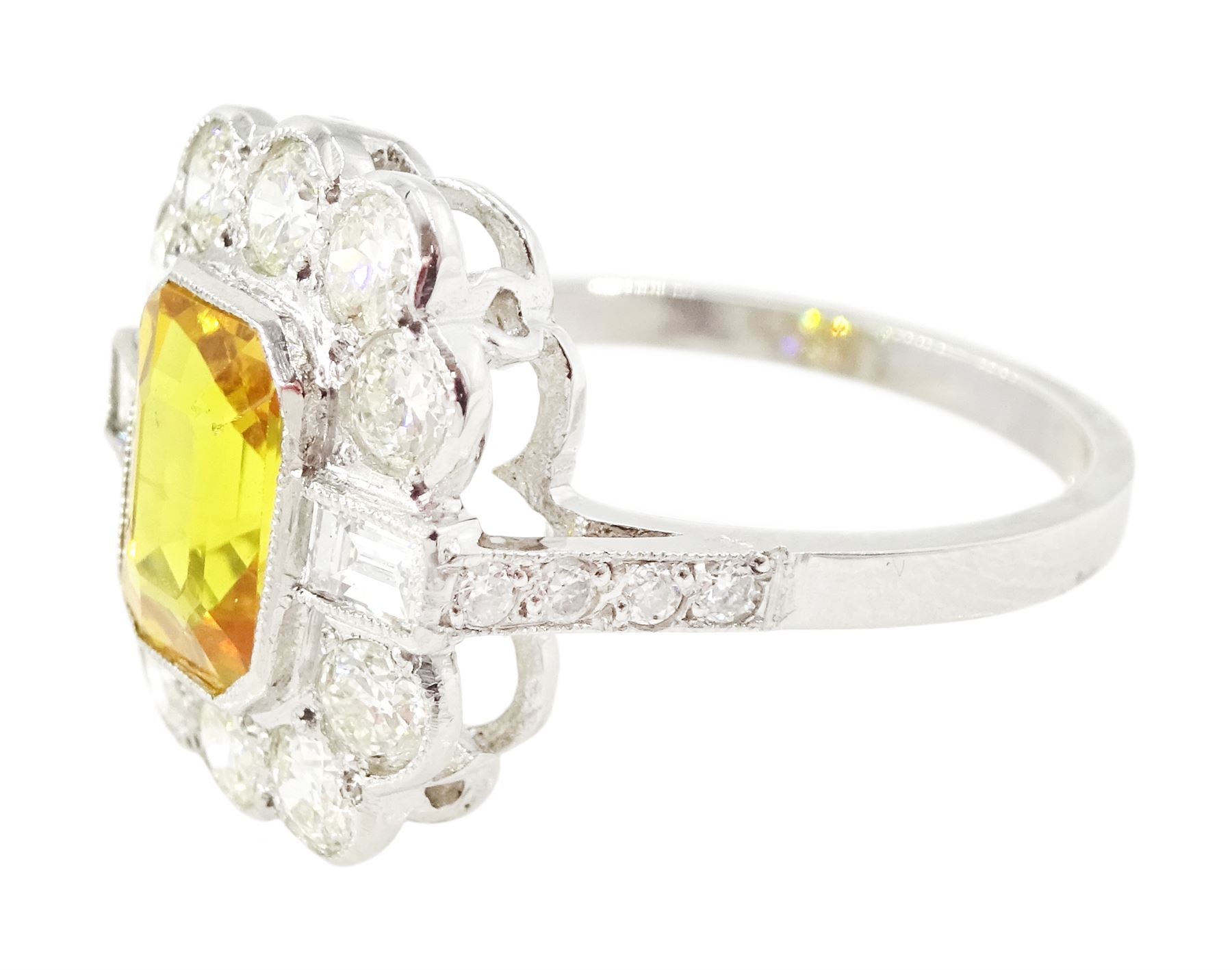 Platinum yellow sapphire and diamond milgrain set cluster ring, single octagonal cut sapphire of approx 2.20 carat, surrounded by two baguette cut diamonds and ten transitional cut diamonds and diamond set shoulders, stamped Plat, total diamond weight approx 0.95 carat
