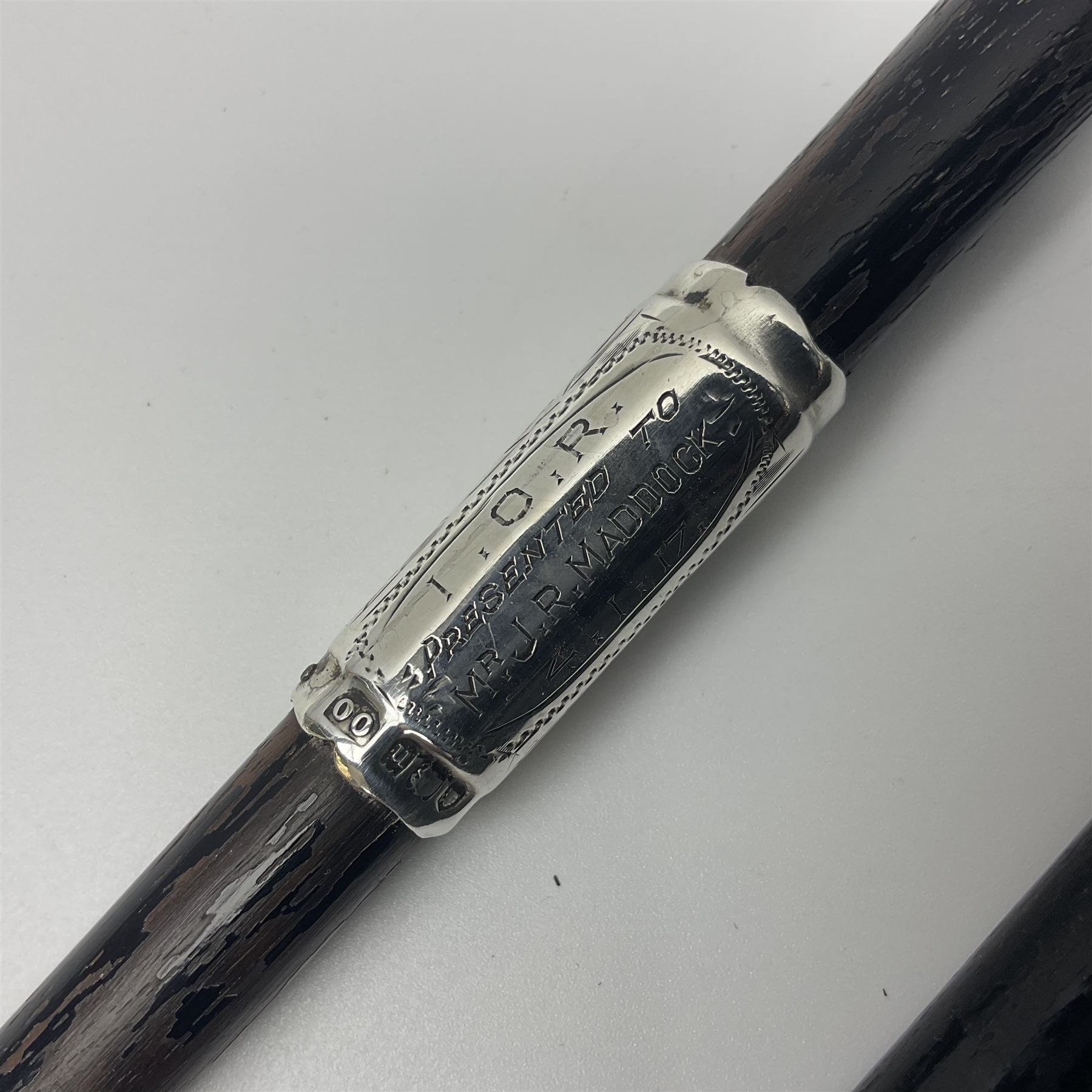Two early 20th century conductor's ebonised batons each with three silver mounts; one hallmarked London 1915 with presentation plaque 'I.O.R. Presented to Mr. J.R. Maddock 4.1.17' L52cm; the other hallmarked Chester 1908 with vacant cartouche L51.5cm (2)